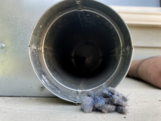 Spring Hill Dryer Vent Cleaning technician using specialized equipment to clear severe dryer vent blockage in Spring Hill